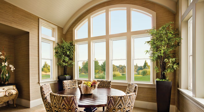 Bright dining room framed by a wall of Alside Mezzo windows